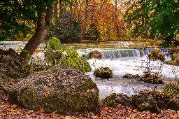 Scenic view of waterfall on Isar river in English Garden Park, Munich, Germany.