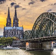 Cologne, Germany at the cathedral and bridge over the Rhine River.