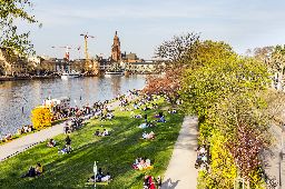 People enjoy the first warm spring day on March in Frankfurt, Germany