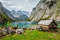 Boat dock hangar on Obersee mountain lake in Alps. Bavaria, Germany