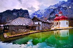 Mountain lake Konigsee in german Alps near Munich with St Bartholomew church