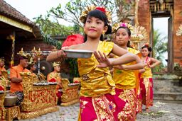 Young dancers perform a welcome dance in a 'Full Moon Ceremony' in the Bedulu village, Ubud, Bali