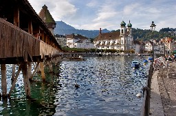 Lucerne lake quay with wooden bridge and a church